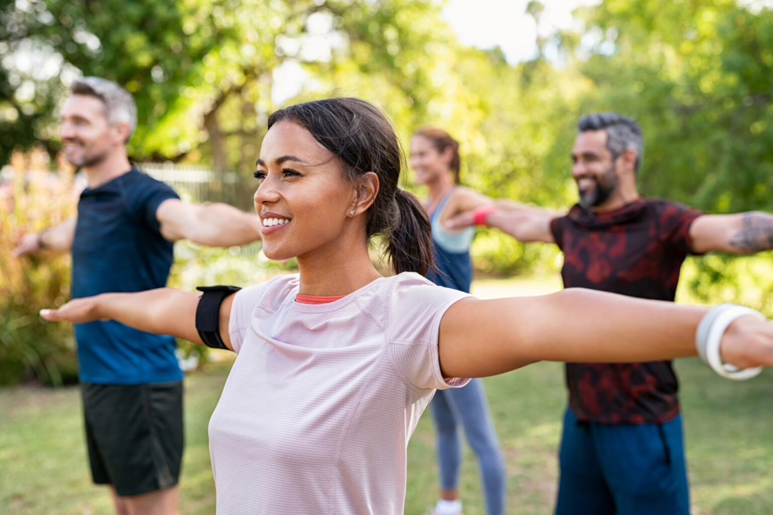 doctor walking a patient through a balance test Group of people exercising in the park