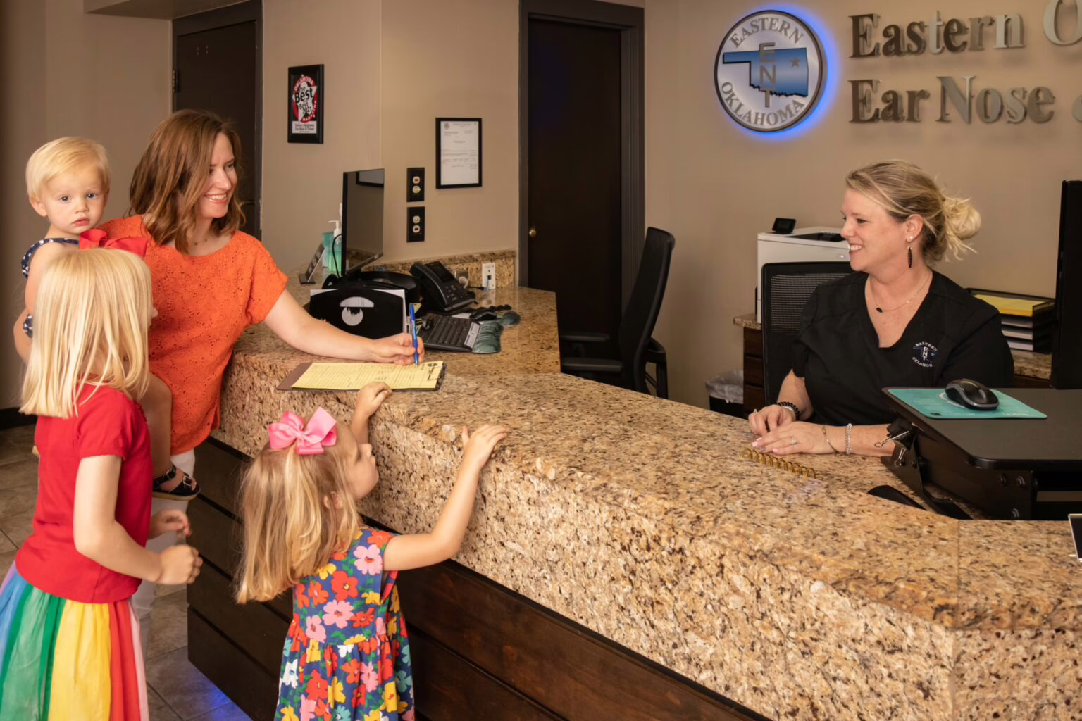 Pediatric-Allergy-symptoms Parent checking in daughter at pediatric allergy appointment
