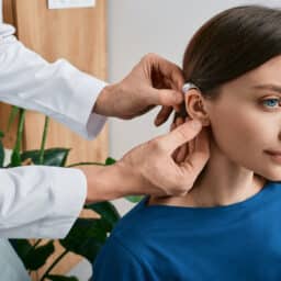 Woman is fitted for hearing aid