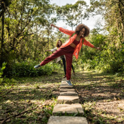 Young women walking on stones during hiking in the forest